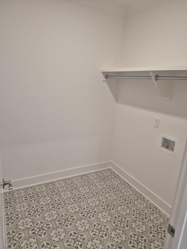 laundry room featuring hookup for a washing machine, laundry area, baseboards, and tile patterned floors