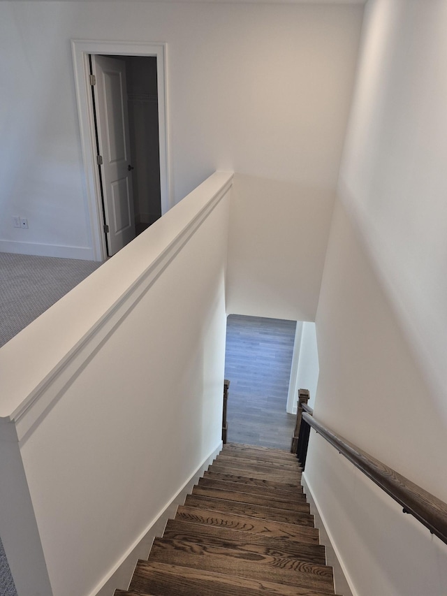 staircase featuring wood finished floors