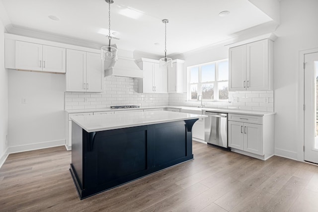 kitchen with light wood-style floors, a center island, white cabinets, and stainless steel dishwasher