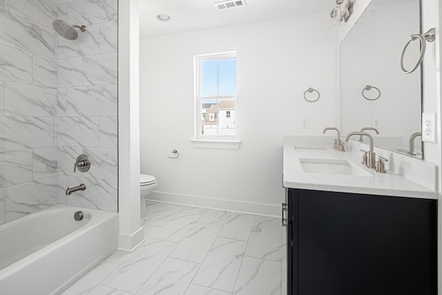 bathroom with marble finish floor, double vanity, toilet, a sink, and baseboards