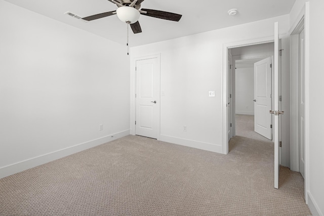 unfurnished bedroom featuring light carpet, ceiling fan, and baseboards