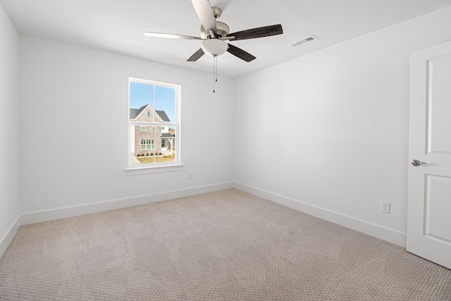 unfurnished room with baseboards, visible vents, ceiling fan, and light colored carpet