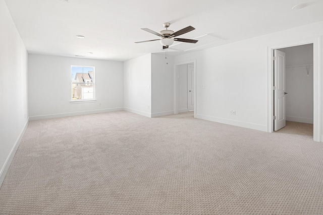 unfurnished room with light carpet, a ceiling fan, and baseboards