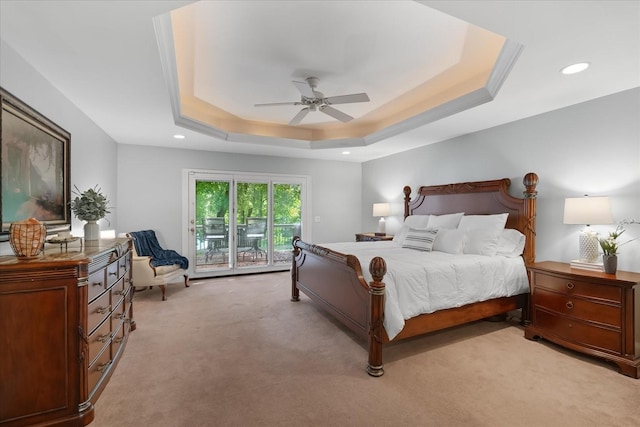 bedroom featuring access to exterior, light carpet, a raised ceiling, and ceiling fan