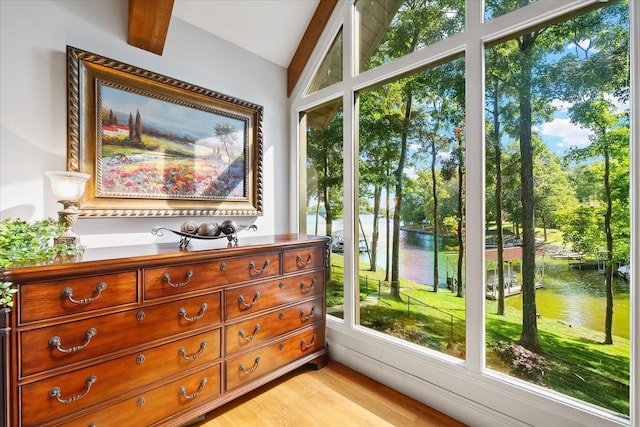 interior space featuring a water view and lofted ceiling