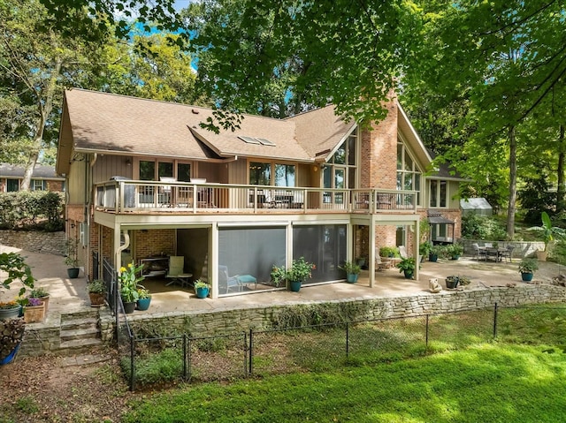 back of house featuring a deck and a patio