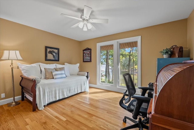 bedroom with light hardwood / wood-style floors and ceiling fan