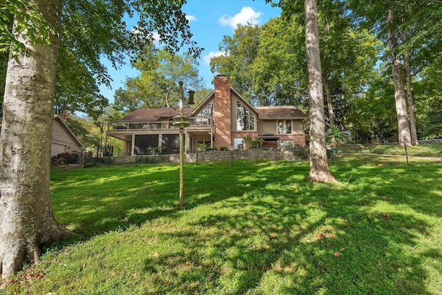 rear view of house with a yard