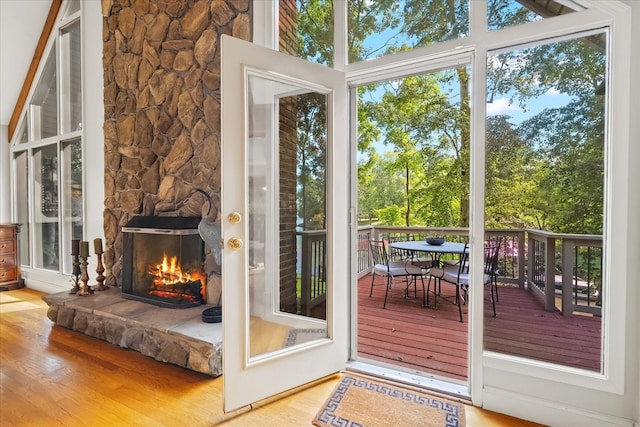 entryway with a stone fireplace and hardwood / wood-style floors