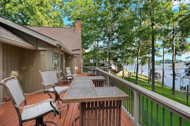 deck featuring a yard and a water view