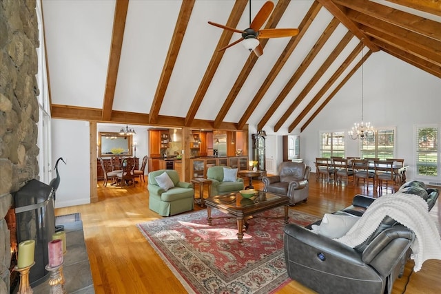 living room featuring beam ceiling, high vaulted ceiling, wood-type flooring, and ceiling fan with notable chandelier