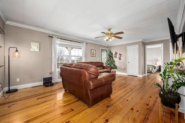 living room with light wood-type flooring, ceiling fan, and ornamental molding