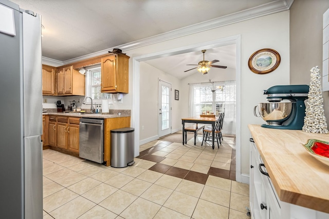 kitchen with a wealth of natural light, sink, light tile patterned floors, and appliances with stainless steel finishes