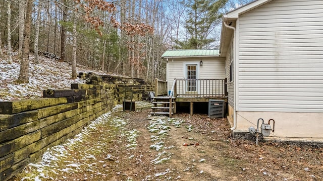 view of yard with central AC unit and a wooden deck