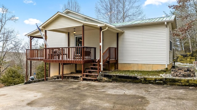 rear view of house featuring a deck