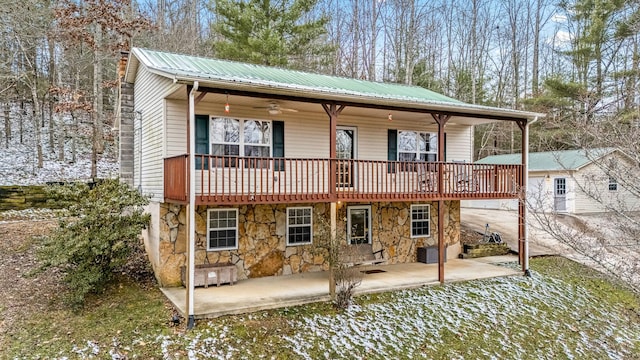 rear view of property featuring ceiling fan, a patio area, and a wooden deck