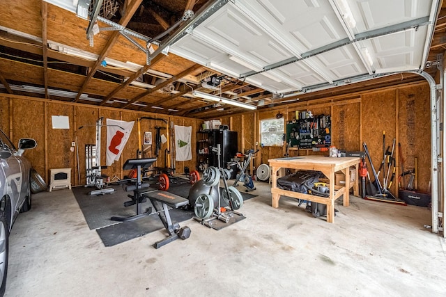 garage with a workshop area and a garage door opener