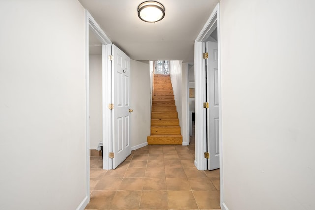 hall with light tile patterned floors