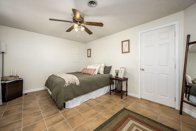 tiled bedroom with ceiling fan