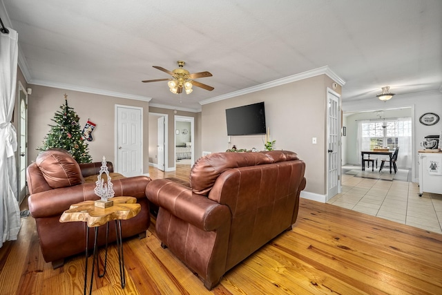 living room featuring light hardwood / wood-style floors, ceiling fan, and crown molding