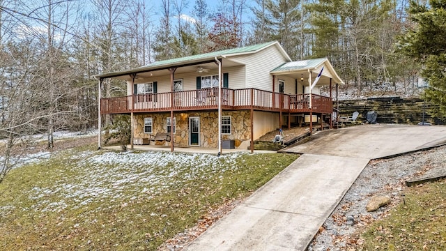 view of front property with ceiling fan and a wooden deck