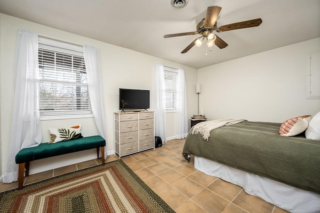 tiled bedroom featuring ceiling fan