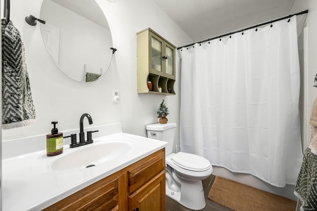 full bathroom with tile patterned flooring, vanity, shower / tub combo, and toilet