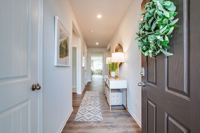 corridor with wood-type flooring