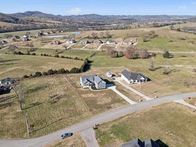 birds eye view of property featuring a mountain view and a rural view