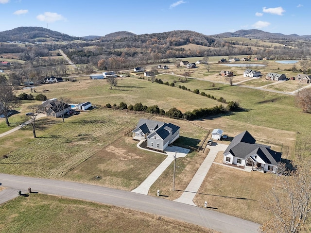 drone / aerial view featuring a mountain view and a rural view