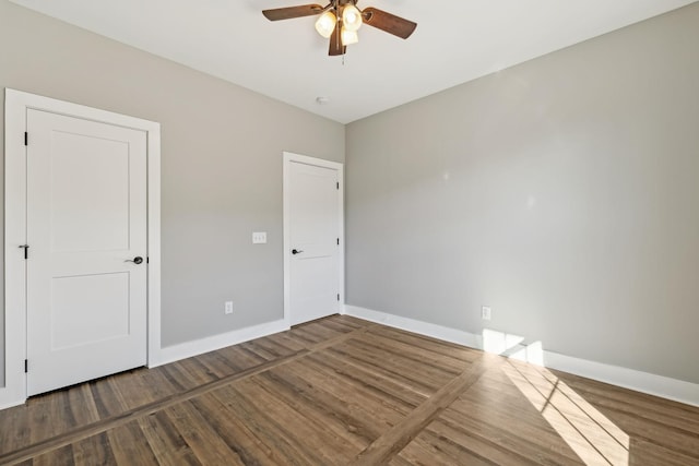 unfurnished room featuring dark hardwood / wood-style floors and ceiling fan