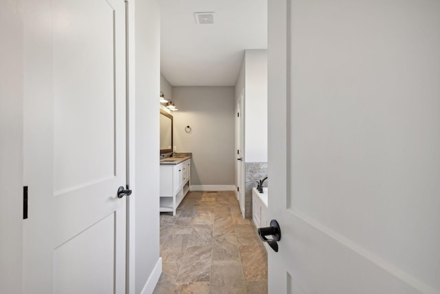 bathroom with a bath and vanity