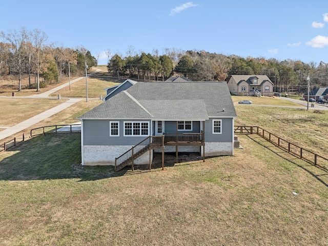 rear view of property featuring a yard