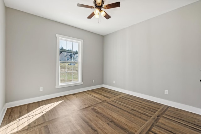 empty room with hardwood / wood-style floors and ceiling fan