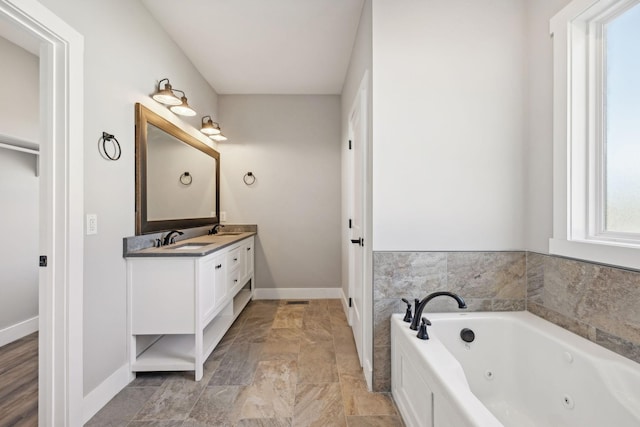 bathroom with vanity and a tub to relax in