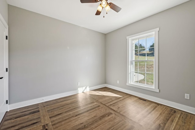 empty room with dark hardwood / wood-style floors and ceiling fan