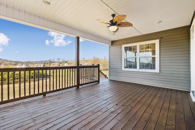 wooden deck featuring ceiling fan