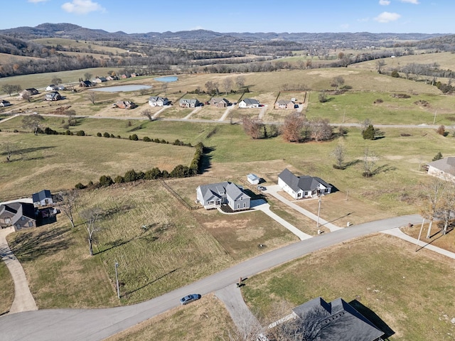 drone / aerial view with a mountain view and a rural view