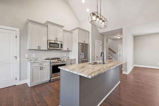 kitchen with light stone countertops, sink, dark hardwood / wood-style floors, and appliances with stainless steel finishes