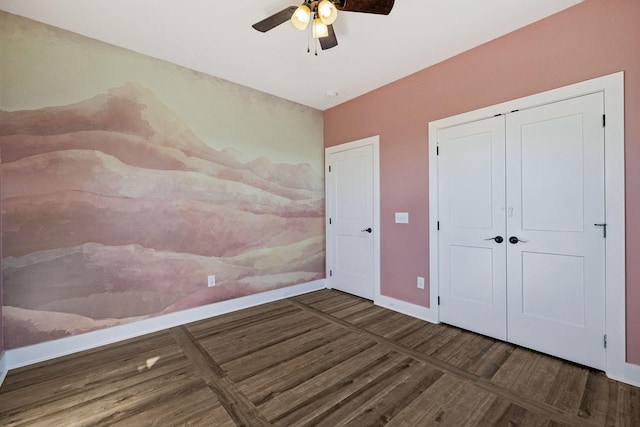 unfurnished bedroom with ceiling fan, a closet, and dark wood-type flooring