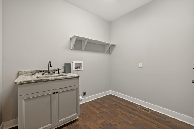 laundry area with hookup for an electric dryer, dark hardwood / wood-style flooring, sink, and hookup for a washing machine