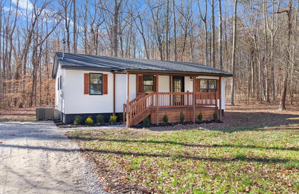 ranch-style house with a front lawn and central AC unit