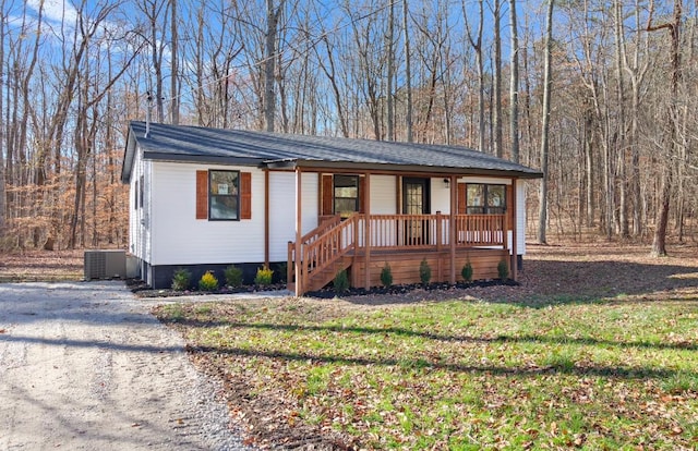 ranch-style house with a front lawn and central AC unit