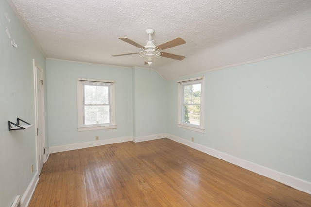 unfurnished room featuring a textured ceiling, hardwood / wood-style flooring, plenty of natural light, and ceiling fan