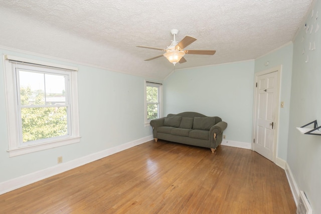 sitting room featuring hardwood / wood-style floors, a textured ceiling, plenty of natural light, and ceiling fan