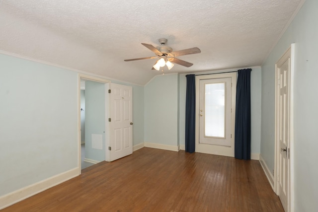 empty room with a textured ceiling, dark hardwood / wood-style floors, and ceiling fan