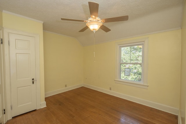 spare room featuring hardwood / wood-style floors, ceiling fan, a textured ceiling, and vaulted ceiling