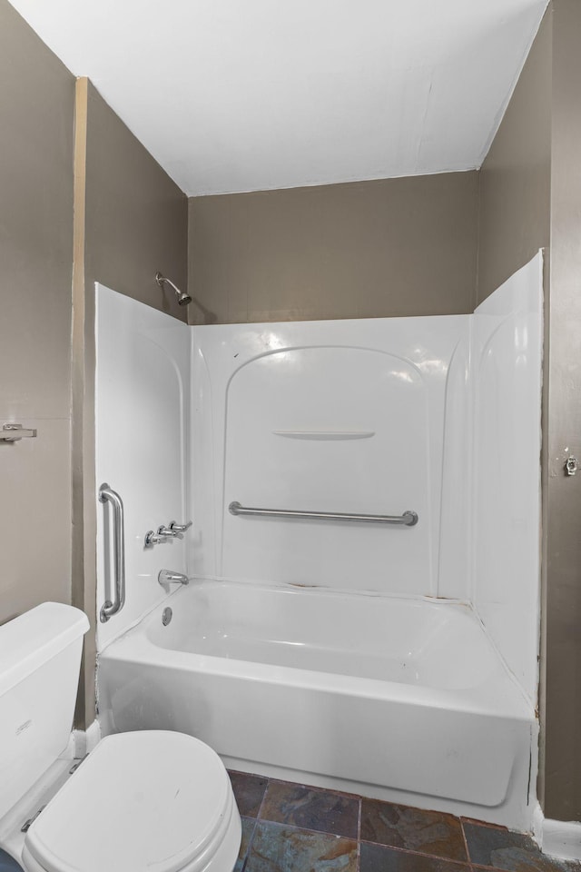 bathroom featuring toilet and bathing tub / shower combination