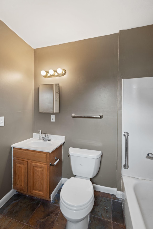 bathroom with a bath, vanity, and toilet