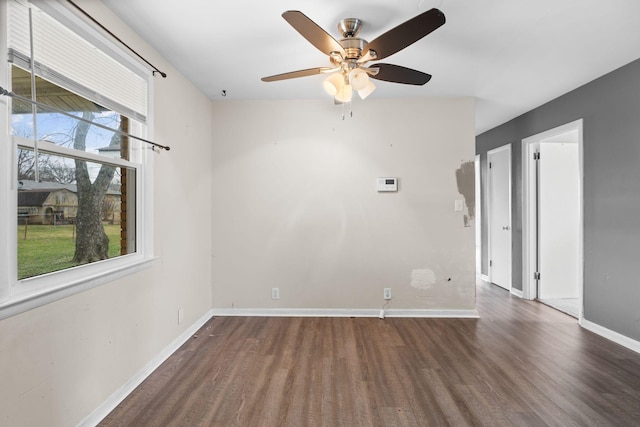 spare room with ceiling fan and dark hardwood / wood-style flooring